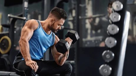 Bodybuilder pumping his biceps dumbbell 260nw 2471712207